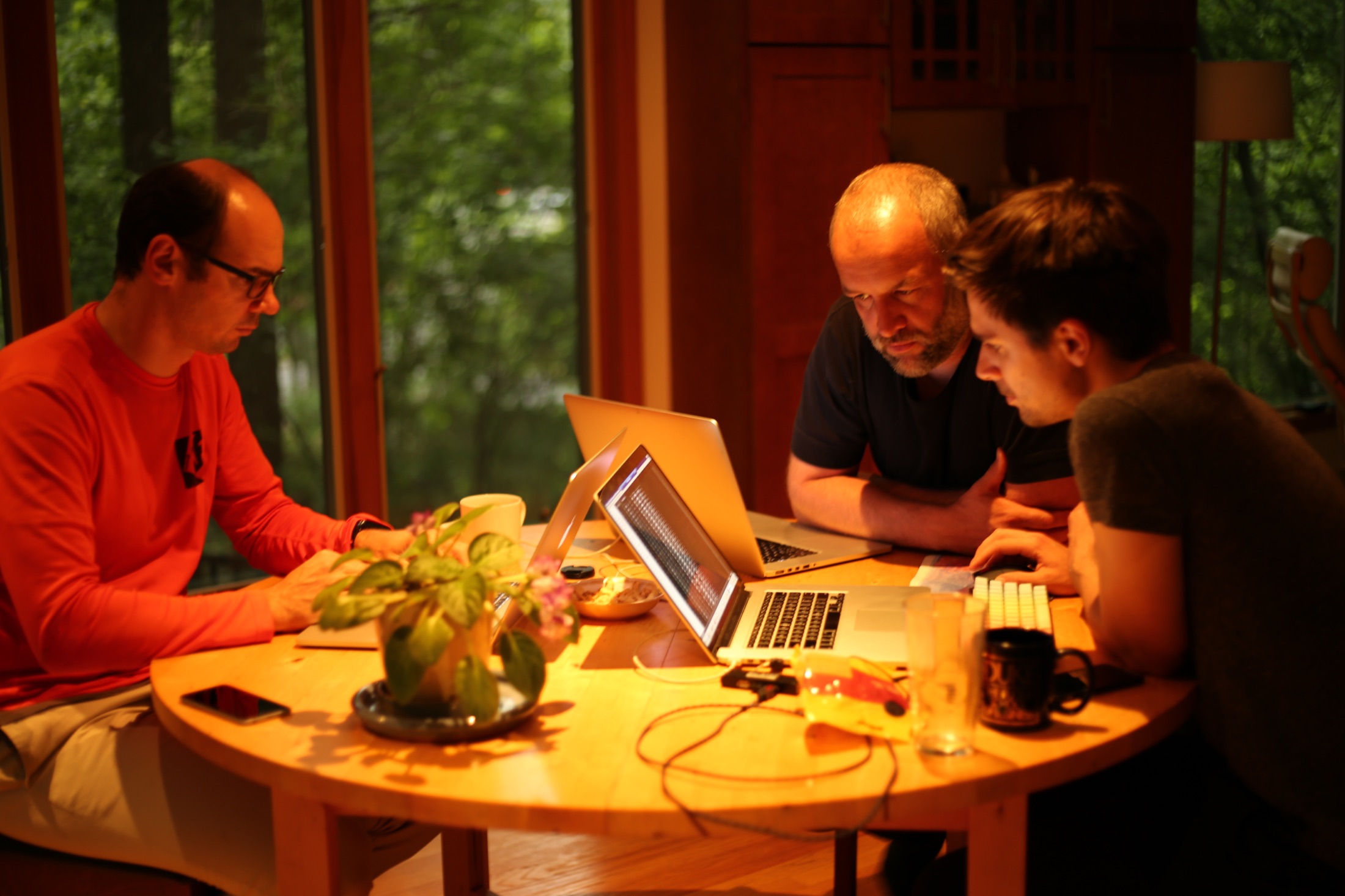 Co-authors Fedor Iskhakov, Bertel Schjerning, and Anders Munk-Nielsen working together around a table